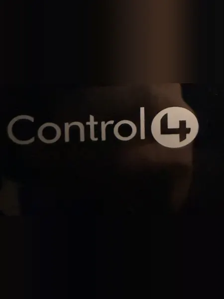 Control4 logo on the front of a black glossy unit