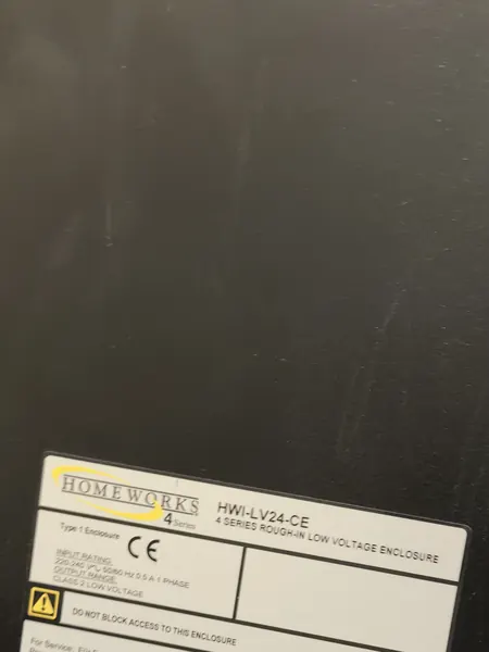 Label on a black Lutron enclosure reading HomeWorks 4 Series and 4 Series rough-in low voltage enclosure