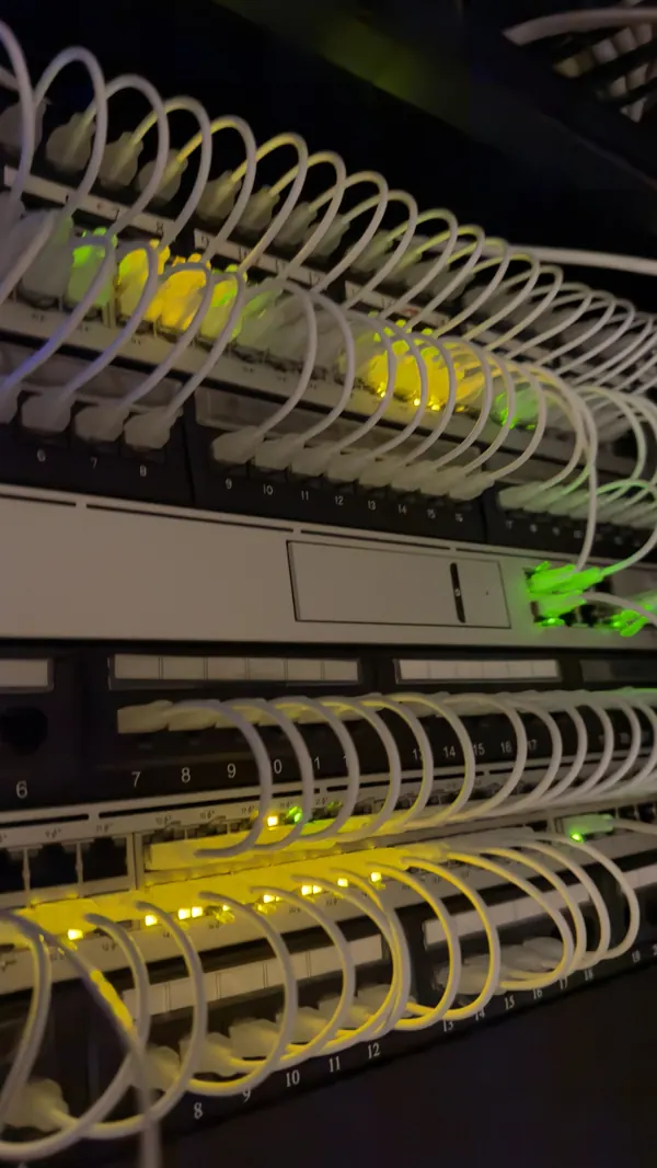Close up of the finished Cat6 patching in Cork, with matching short white patch leads between the patch panels and network switches