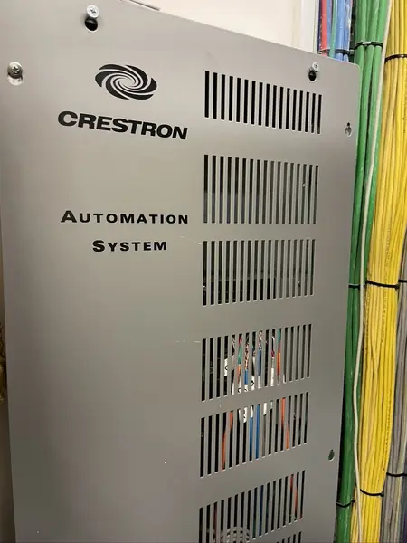 Grey Crestron Automation System enclosure with control modules and cables inside