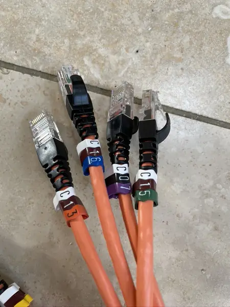 Orange network patch leads with labels C07, C13, C15 and C16, made up before fitting