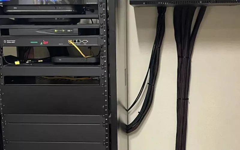 Equipment rack with neatly dressed cables running back from every room of the house