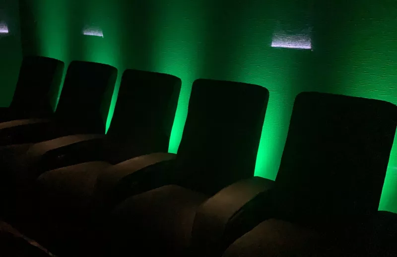 The same seats with the wall behind them switched to green, and small wall lights higher up