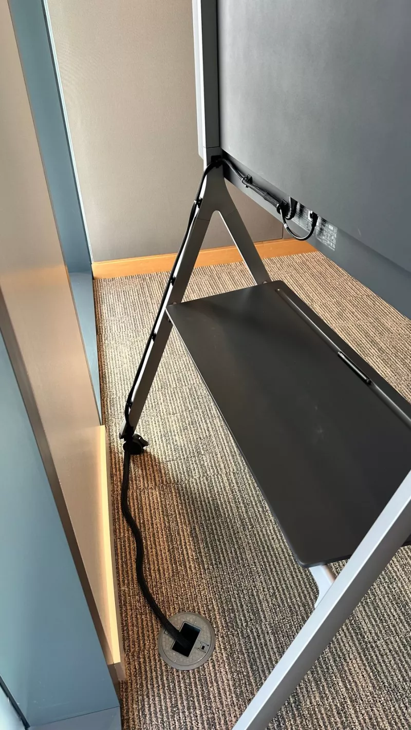 Back of the Neat Board stand with the cable running down to a box set in the floor
