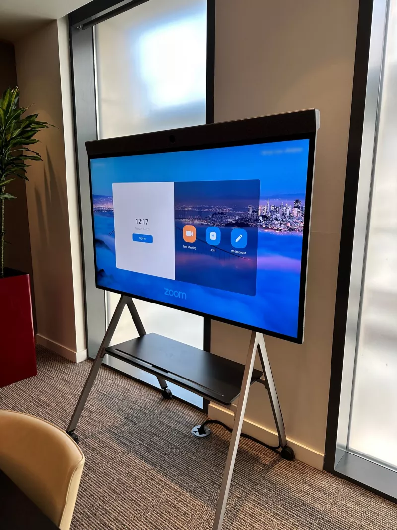 Neat Board on its floor stand showing the Zoom Rooms home screen with test meeting, join and whiteboard buttons
