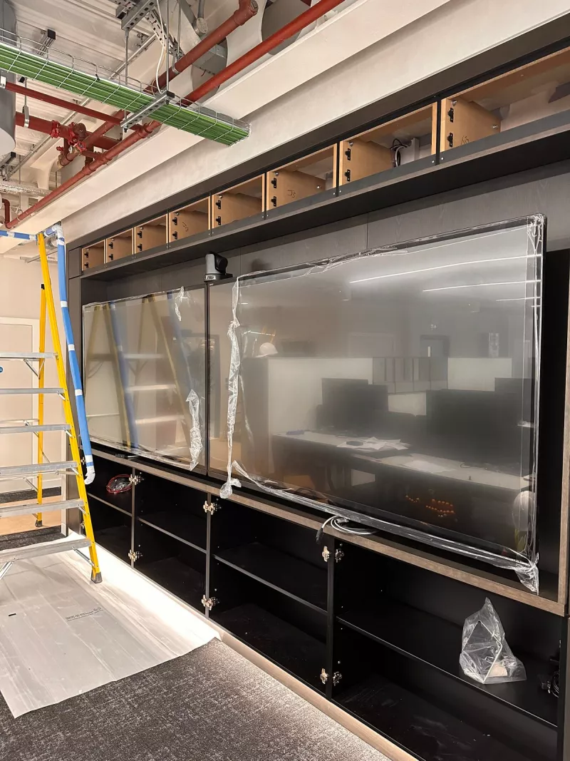 The two displays in place in the joinery, still wrapped in protective film, with a camera fixed above