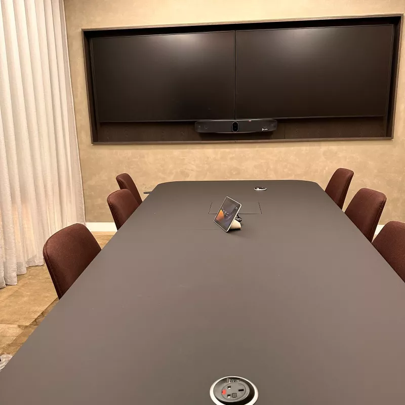 From the far end of the table: the touch controller and a power socket in the tabletop, facing the two screens and the bar
