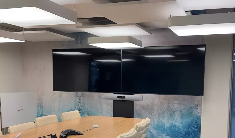 A boardroom in south Dublin with two large screens side by side on a floor stand and a Cisco video bar fixed below them