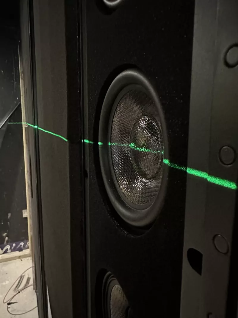 One of the hidden speakers, lined up with a laser level before the fabric wall goes on