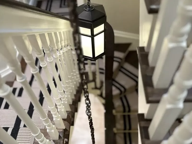 Lantern pendants lighting a sweeping staircase in a Malahide home, Dublin