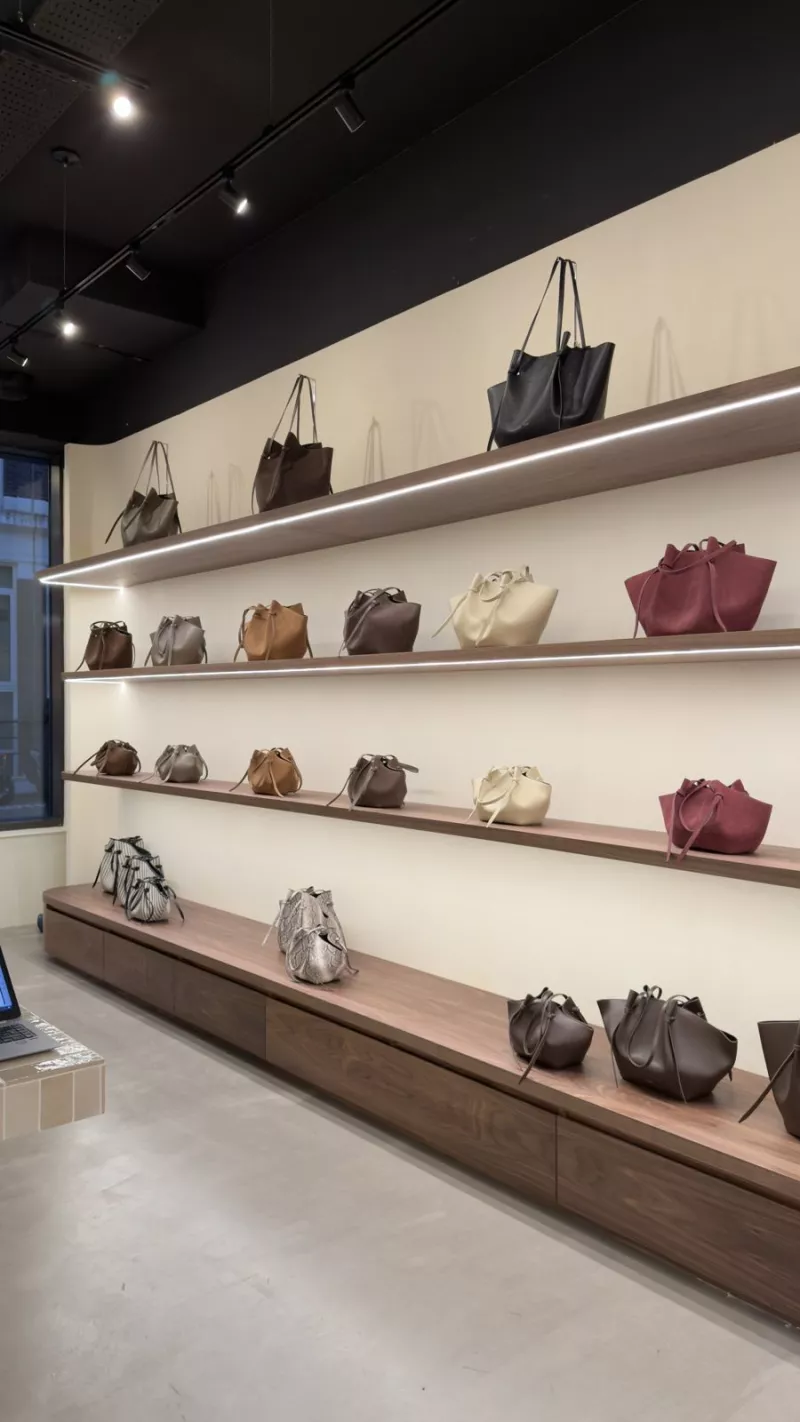 Walnut shelves with LED lighting controlled by Crestron in the boutique