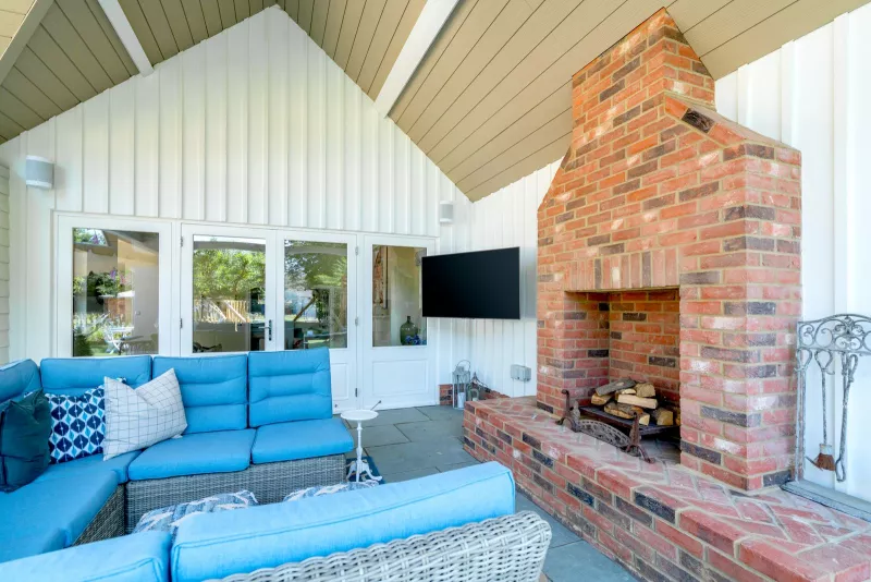 Outdoor seating and TV by the fireplace