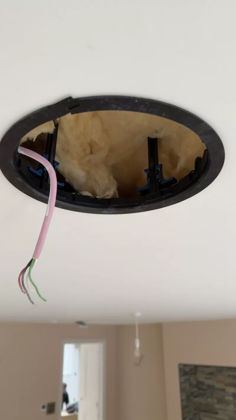 A ceiling speaker being fitted