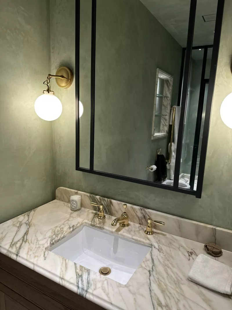 Bathroom with lit mirror and wall lights