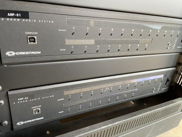 Two Crestron six room audio systems in an equipment rack, labelled AMP-01 and AMP-02