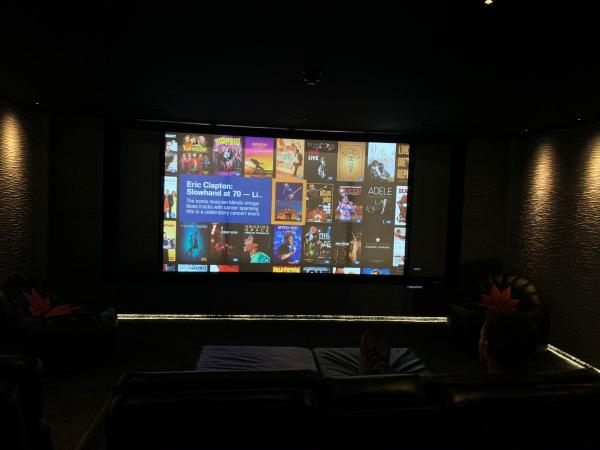 A film menu on the big screen in the darkened cinema room