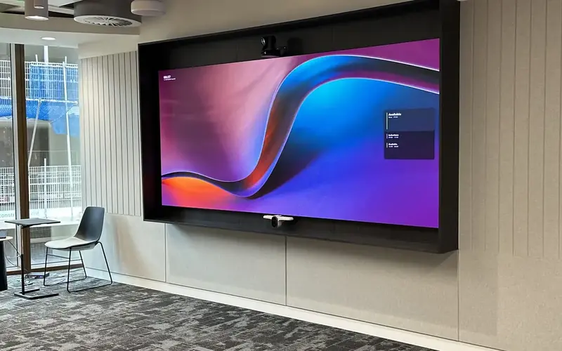 Commercial display on a wall in a modern office, with patterned grey carpet