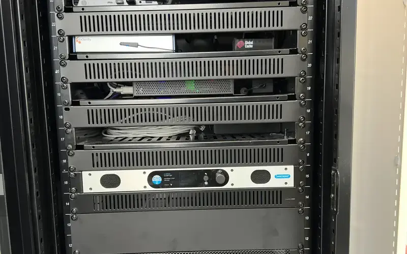 AV equipment rack with an amplifier and processing units, cleanly installed