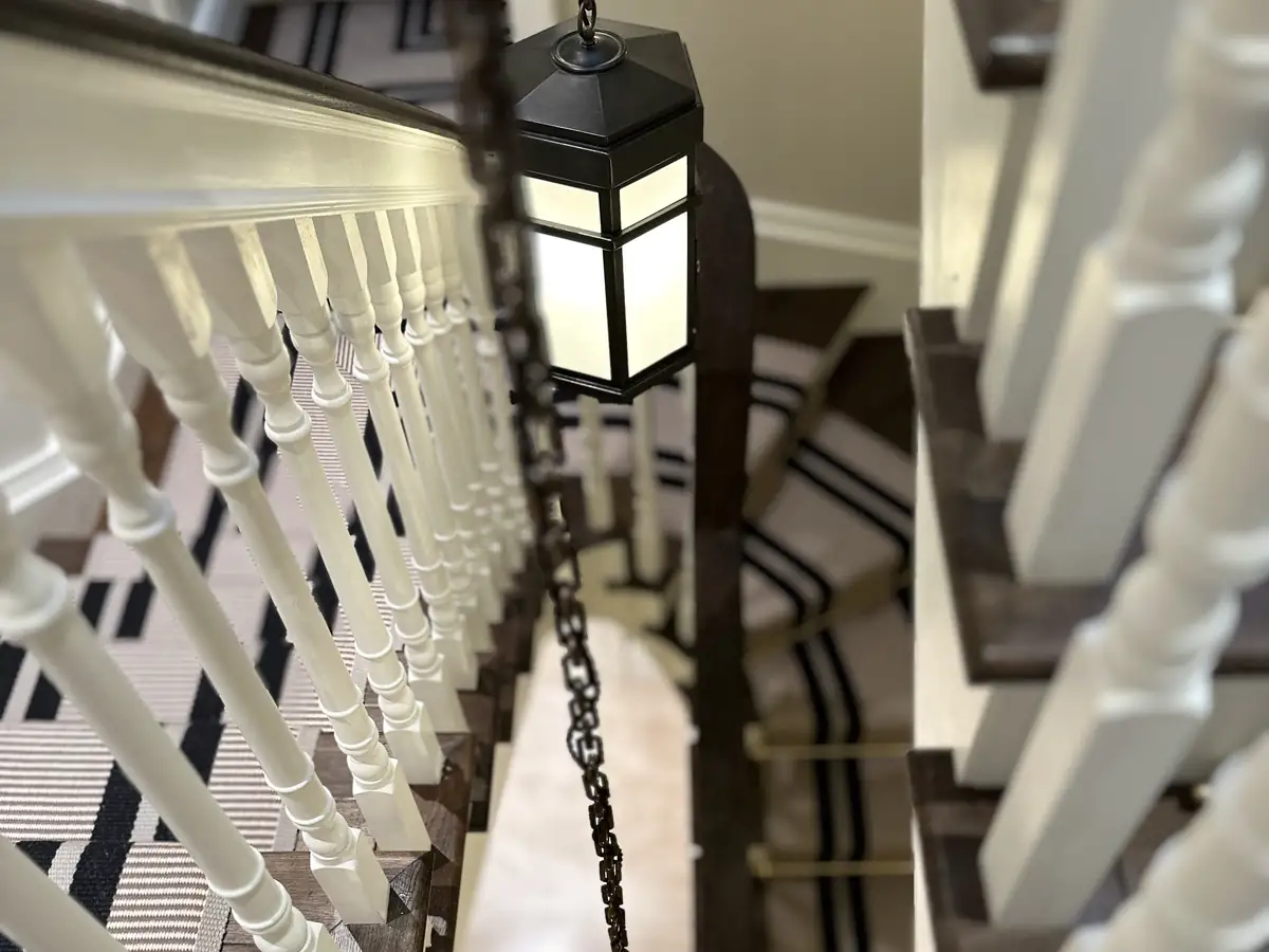 Lantern pendants lighting a sweeping staircase